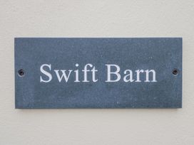 A nameplate with the text Swift Barn at Swift Barn in Wigton