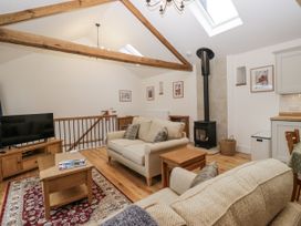 A living room with a sofa and television at Swift Barn in Wigton