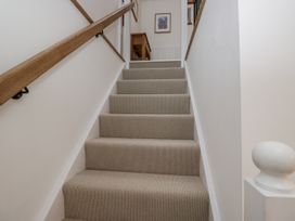 A staircase with a handrail leading upstairs at Swift Barn in Wigton