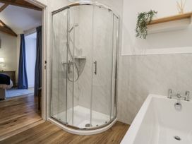 A bathroom with a shower and a bathtub at Swift Barn in Wigton