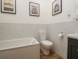 A bathroom with a bathtub and toilet at Swift Barn in Wigton