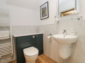 A bathroom with a toilet and sink at Swift Barn in Wigton