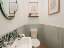 A bathroom with a toilet and a sink at Swift Barn in Wigton