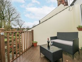 An outdoor area with a sofa and table at Swift Barn, Wigton