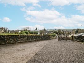 An outdoor view of a gravel path and gate at Swift Barn in Wigton