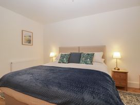 A bedroom with a bed and bedside table at Swift Barn in Gilcrux