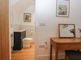 A bathroom with a toilet and vanity at Swift Barn in Gilcrux