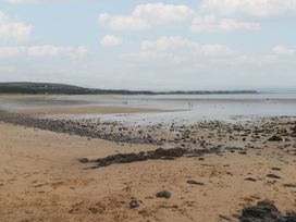A beach landscape with rocks and water at Kites - 52 Gower Holiday Village Scurlage near Port Eynon and Rhossili