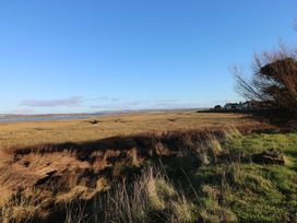 A landscape with grass and water at Kites - 52 Gower Holiday Village Scurlage near Port Eynon and Rhossili
