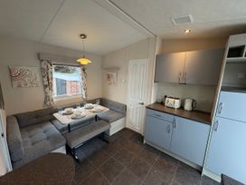 A kitchen with a dining area and appliances at Caravan 941 Clacton-On-Sea