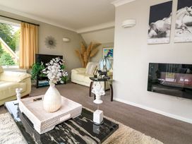 A living room with a sofa, coffee table, and television at 3 Chantry Hill in Kingsbridge
