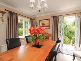 A dining room with a wooden table and chairs at 3 Chantry Hill in Kingsbridge