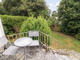 A garden view with a table and chairs at 3 Chantry Hill in Kingsbridge
