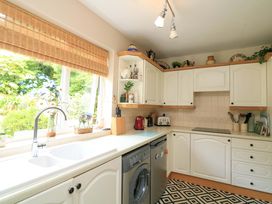 A kitchen with a washing machine and sink at 3 Chantry Hill in Kingsbridge