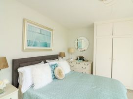 A bedroom with a bed and dresser at 3 Chantry Hill in Kingsbridge