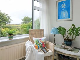 A snug with armchair, side table and plants at 3 Chantry Hill in Kingsbridge