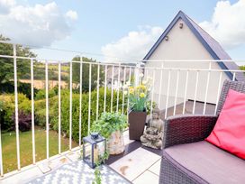 A balcony with outdoor seating and a buddha statue at 3 Chantry Hill, Kingsbridge