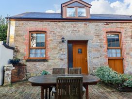 An outdoor area with a table and chairs at The Coach House in Falmouth