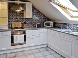 A kitchen with cabinets and appliances at The Coach House in Budock Water near Falmouth