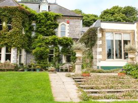 A garden area with steps, benches, and plants at The Coach House Budock Water near Falmouth