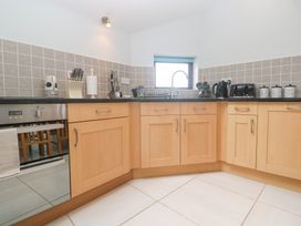 A kitchen with cabinets and appliances at Tobys Quay in Falmouth