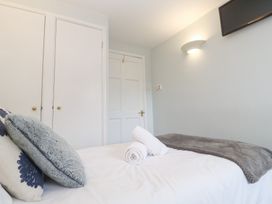 A bedroom with a bed and closet at Tobys Quay in Falmouth
