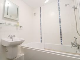 A bathroom with a bathtub and sink at Tobys Quay Falmouth