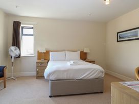 A bedroom with a bed and nightstand at Bedroom 10 in Littlehampton