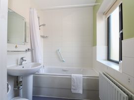 A bathroom with a bathtub and sink at Bedroom 10 in Littlehampton