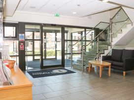 A lobby area with seating and a staircase at The Figtree Lodge in Littlehampton