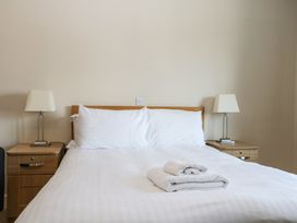 A bedroom with a bed and lamps at Bedroom 9 in Littlehampton