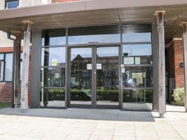 An entrance with glass doors and wooden pillars at Bedroom 9 in Littlehampton