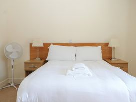 A bedroom with a bed and bedside tables at Sunset Quarters at Marine Court Littlehampton