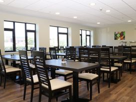 A dining room with tables and chairs at Sunset Quarters at Marine Court Littlehampton