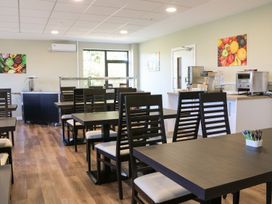 A dining area with tables and chairs at Sunset Quarters at Marine Court Littlehampton