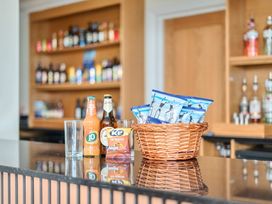 A bar with drinks and snacks at Marine Court First-floor Double Bedroom with Wet Room in Littlehampton