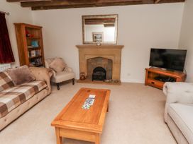 A living room with a fireplace and television at 3 Christon Bank Mews Alnwick