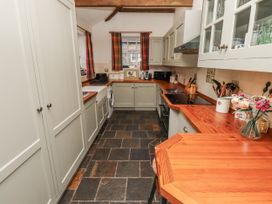 A kitchen with cabinets and appliances at 3 Christon Bank Mews in Alnwick