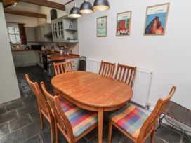A dining room with a wooden table and chairs at 3 Christon Bank Mews Alnwick