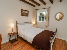 A bedroom with a bed and bedside table at 3 Christon Bank Mews Alnwick