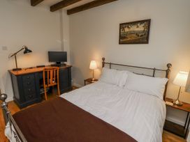 A bedroom with a bed, desk, and computer at 3 Christon Bank Mews in Alnwick