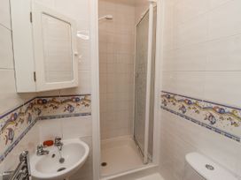 A bathroom with a shower, sink and toilet at 3 Christon Bank Mews Alnwick