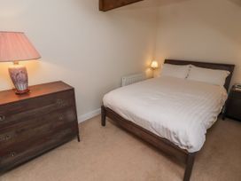 A bedroom with a bed and two lamps at 3 Christon Bank Mews in Alnwick