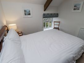 A bedroom with a bed and lamp at 3 Christon Bank Mews Alnwick