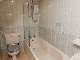 A bathroom with a shower and bathtub at 3 Christon Bank Mews Alnwick