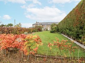 A garden with a house in the background at 3 Christon Bank Mews in Alnwick