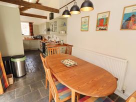 A dining area with table and chairs in a kitchen at 3 Christon Bank Mews Christon Bank