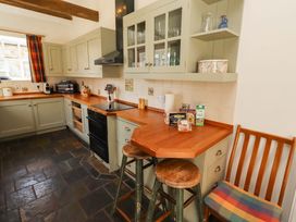 A kitchen with cabinets and counter space at 3 Christon Bank Mews, Christon Bank