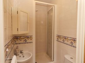 A bathroom with a shower and sink at 3 Christon Bank Mews, Christon Bank