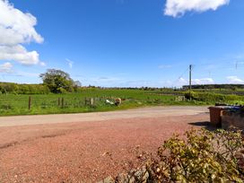 A view of a field with a tree and a road at 3 Christon Bank Mews in Christon Bank